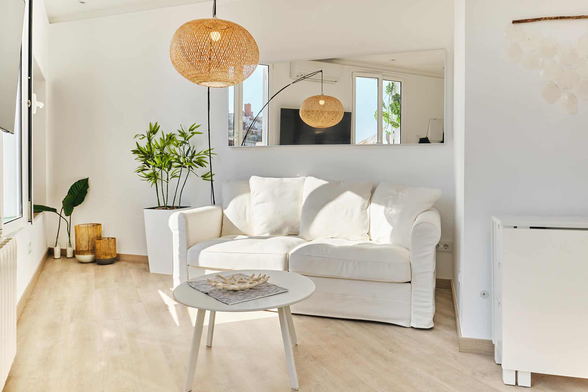 Barcelona roof studio - second-floor studio, living room area with a horizontal mirror above the couch, designed by Beatrice Leupold Barcelona roof studio - second-floor studio, living room area with a horizontal mirror above the couch, designed by Beatrice Leupold